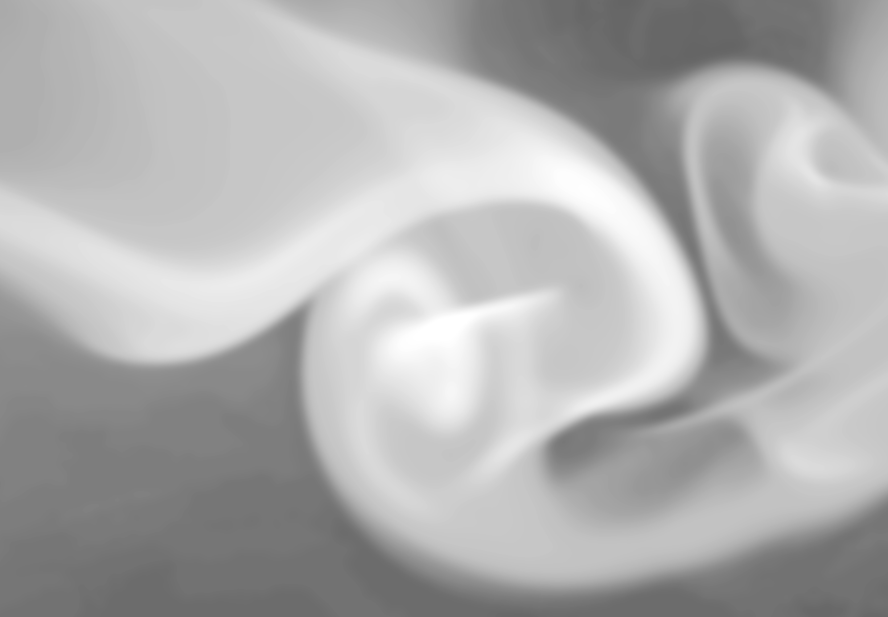 Abstract image with blurred white swirls on a grey background.